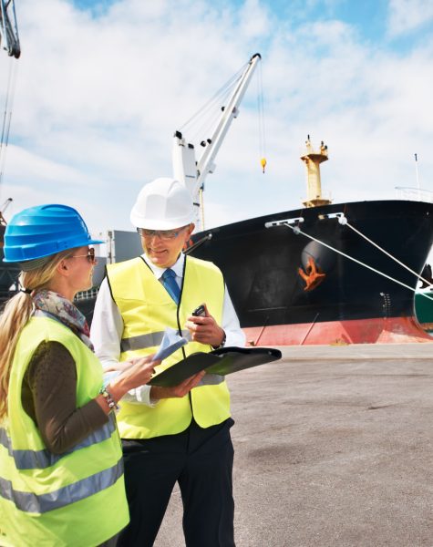 open-communication-brings-results-two-dock-workers-holding-paperwork-while-standing-shipyard-01 (1)